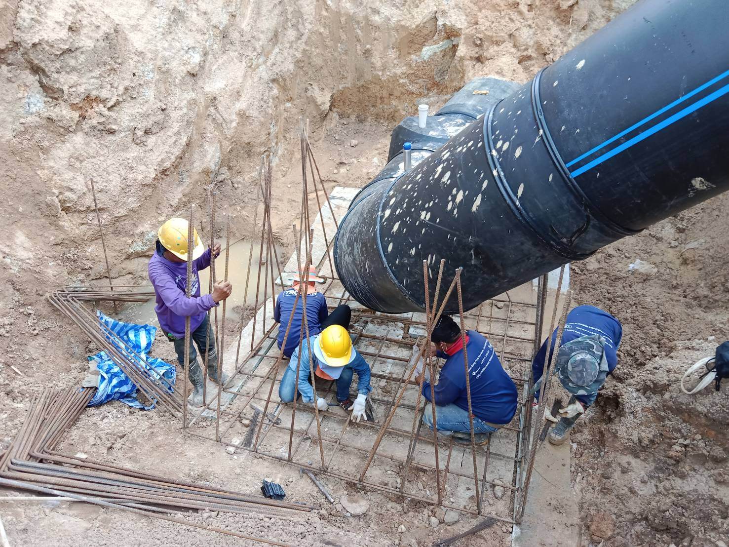 Engineer constructing concrete supports for pipe installation