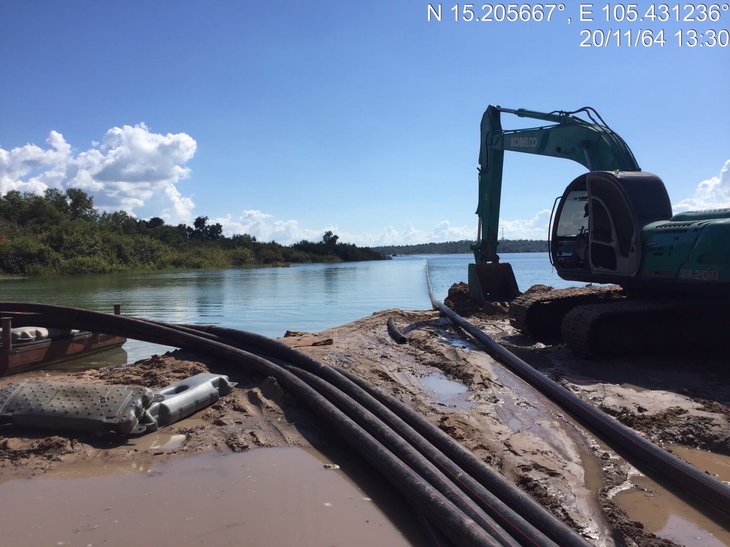 Backhoe excavating and installing HDPE cable ducts for the solar hybrid dam