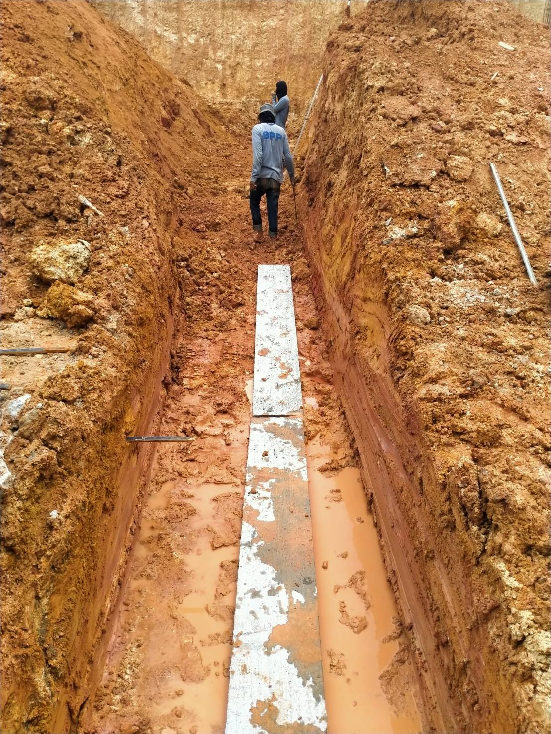 Wooden planks are prepared for laying underground pipes