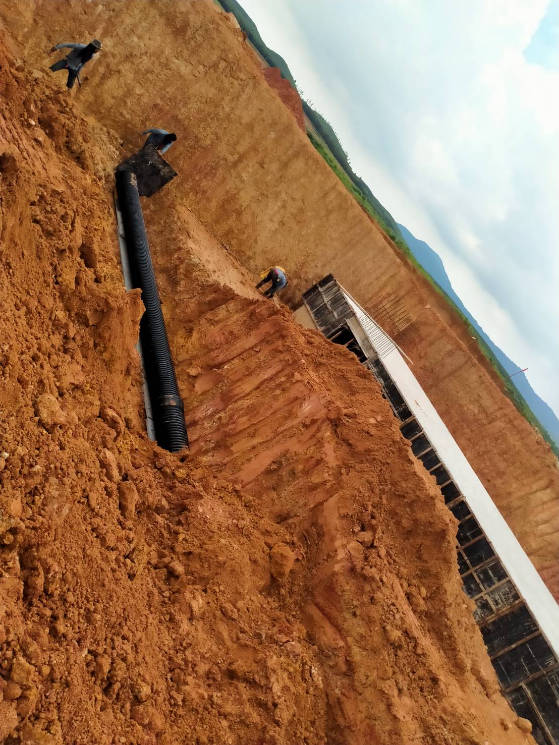 Engineer installing corrugated pipe ( TAPKORR ) in industrial estate