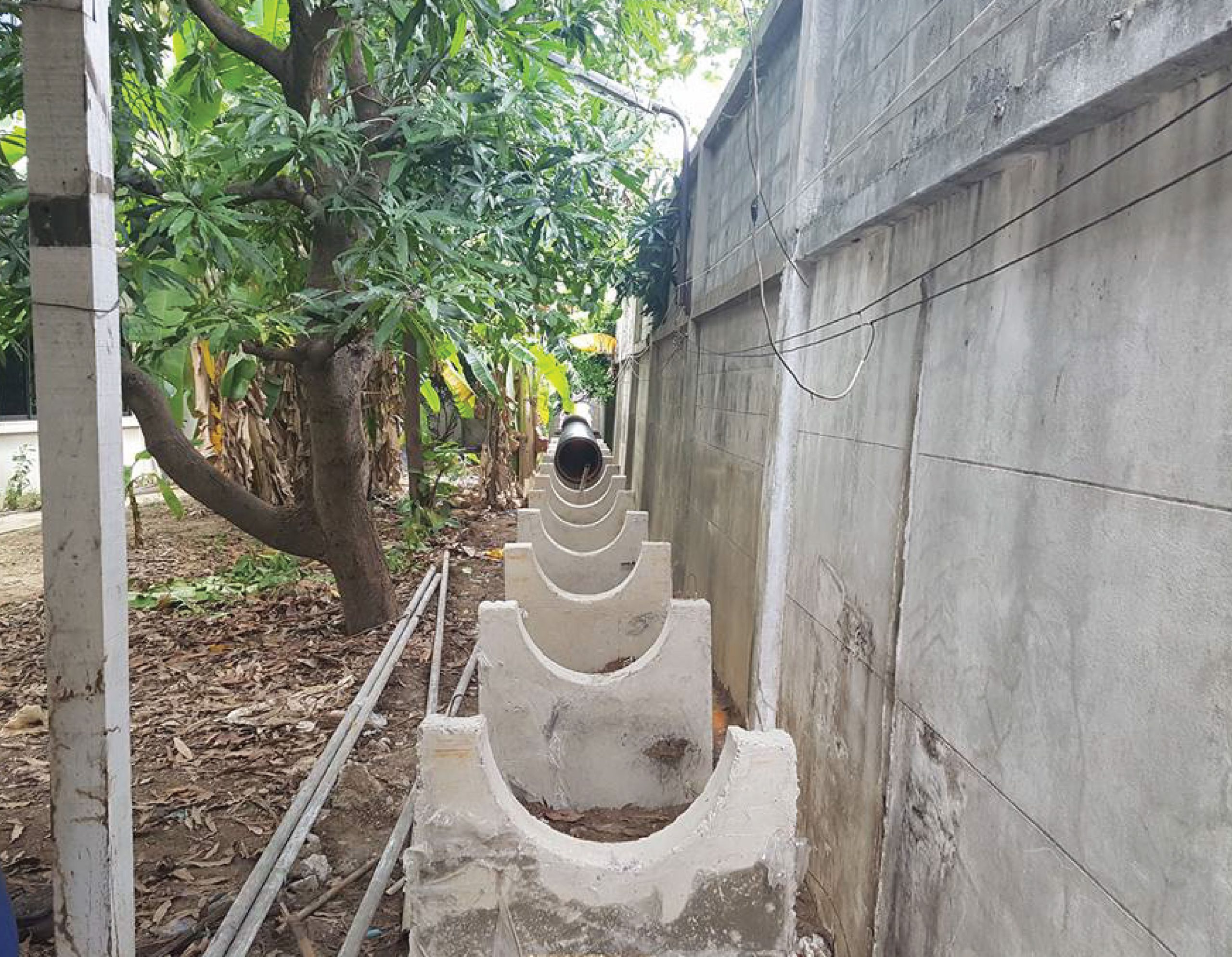 Concrete support for TAPKORR pipe installation in sewer laying works.