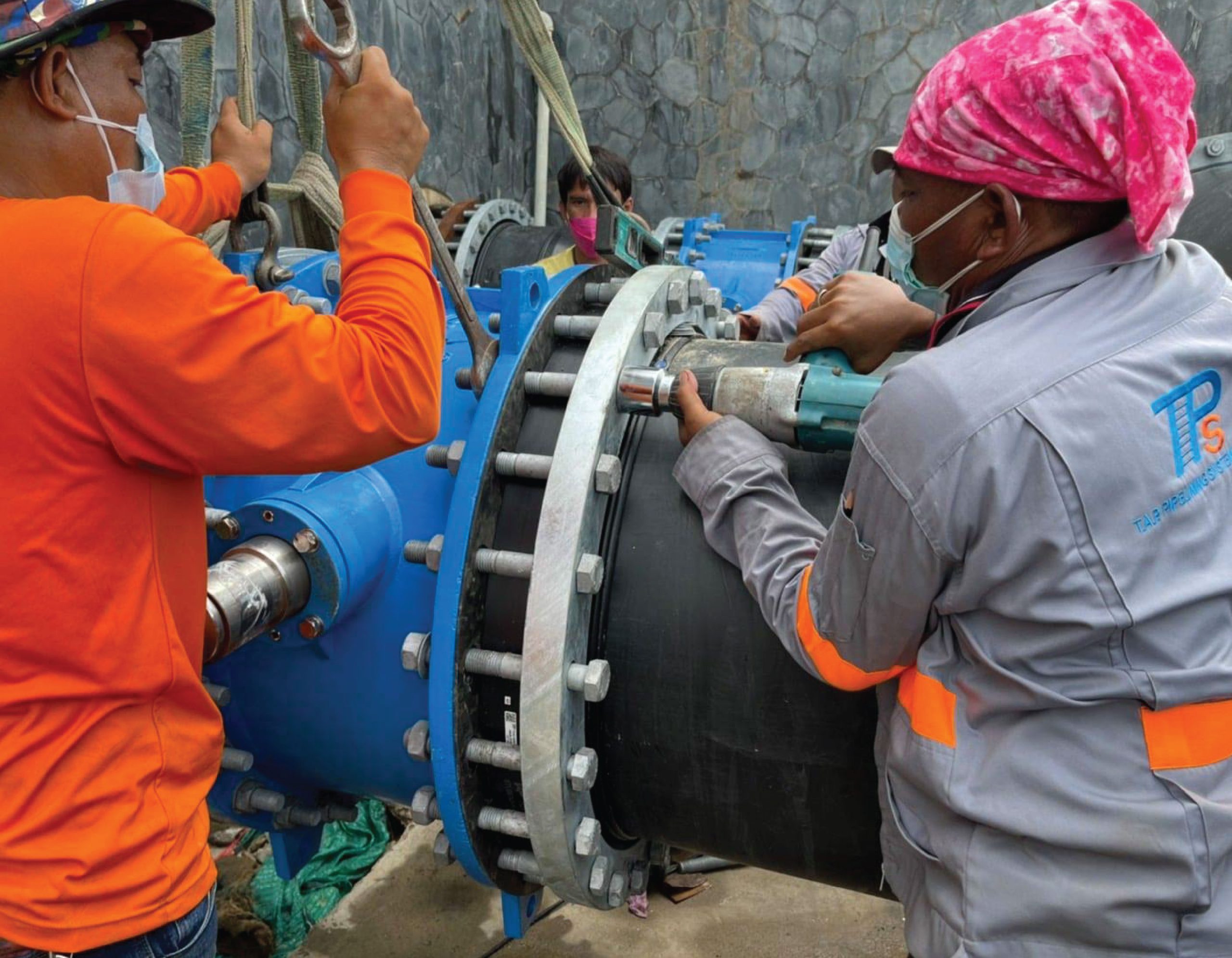 Engineer is connecting a flanged HDPE pipe to a drain to the sea