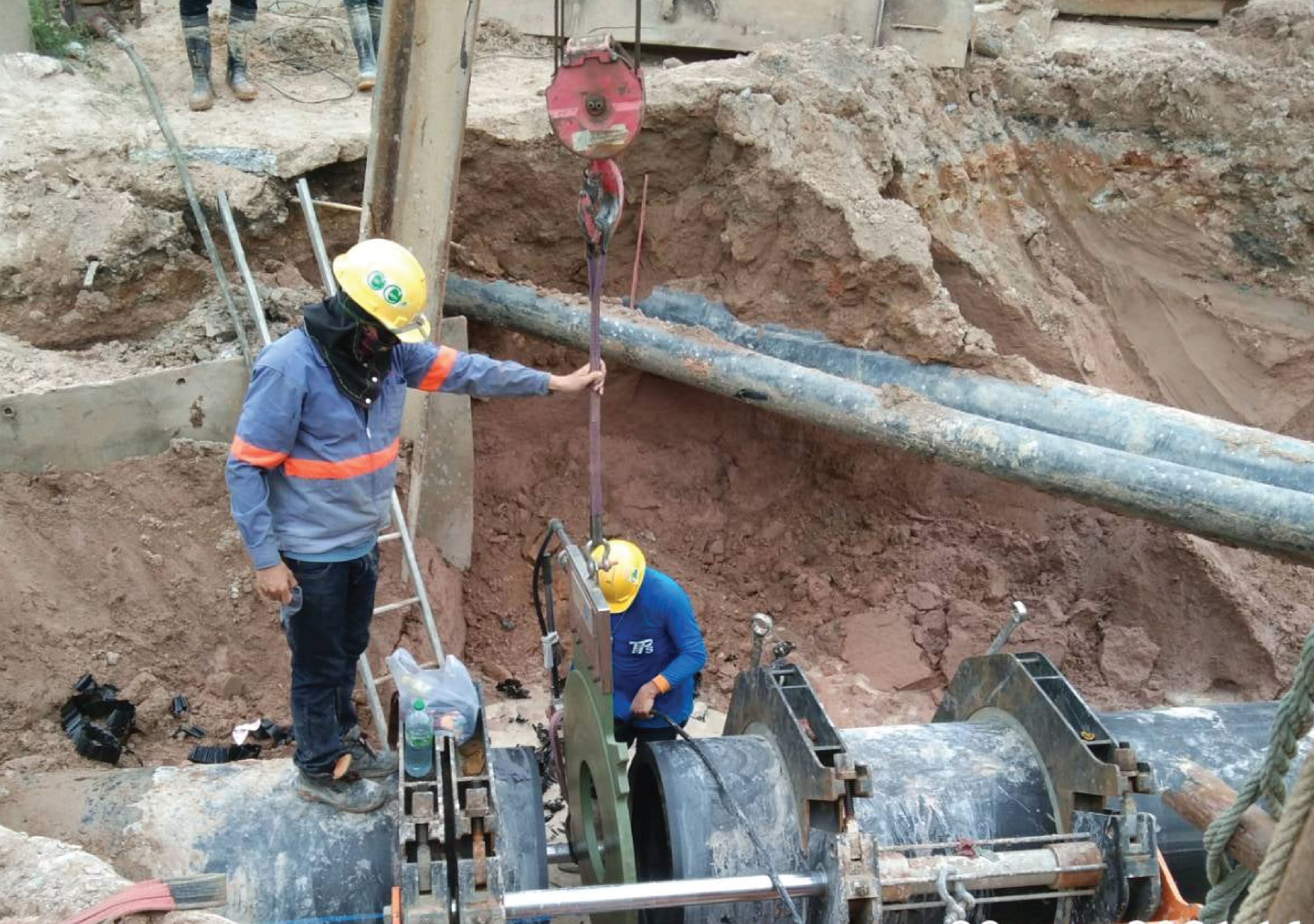 Engineer installing heating plate in butt-fusion HDPE pipe welding method