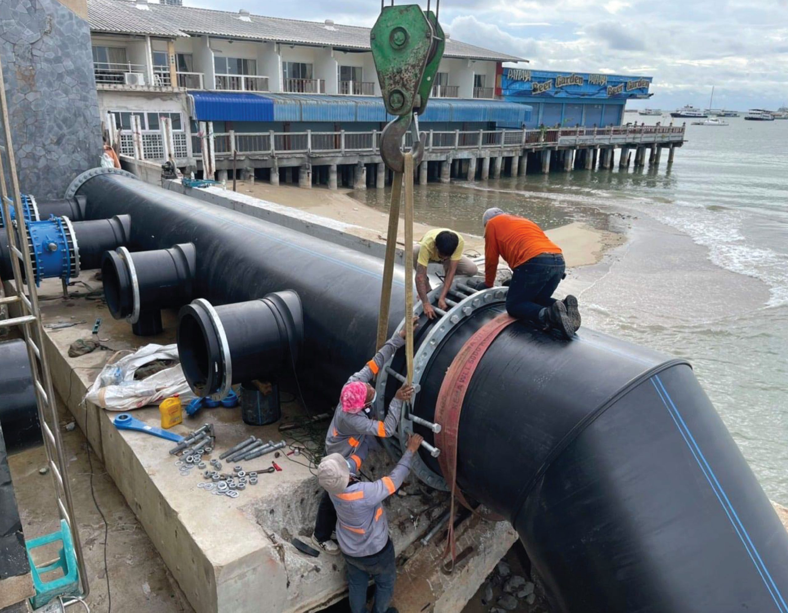 Engineers use a crane to align HDPE pipes with a diameter of 16000 mm.