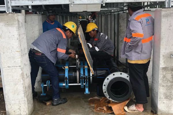 Engineer is connecting HDPE pipes inside a building in a cooling system installed at Robinson, Phuket