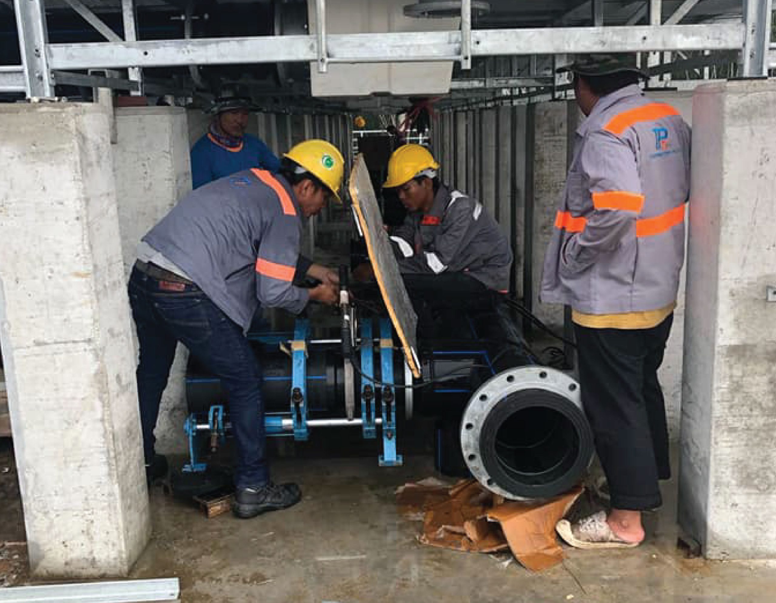 Engineer is connecting HDPE pipes inside a building in a cooling system installed at Robinson, Phuket