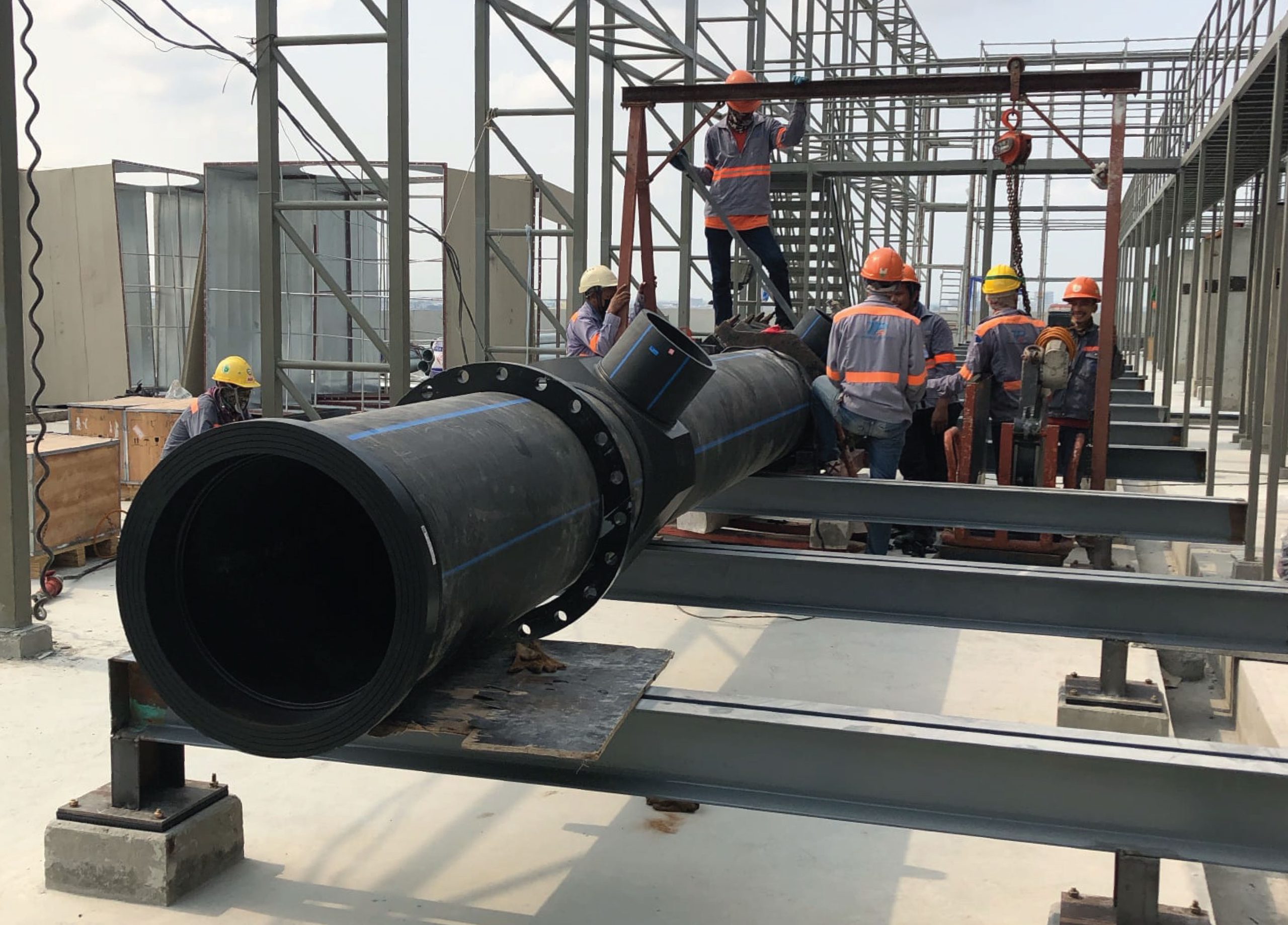 Engineer laying HDPE pipes for cooling system in construction building