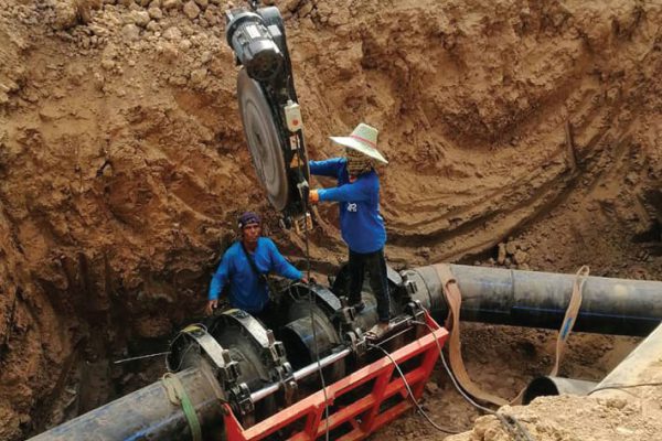 Engineers install a heating pad for butt-fusion welding of HDPE pipes in a drought relief project in Buriram province