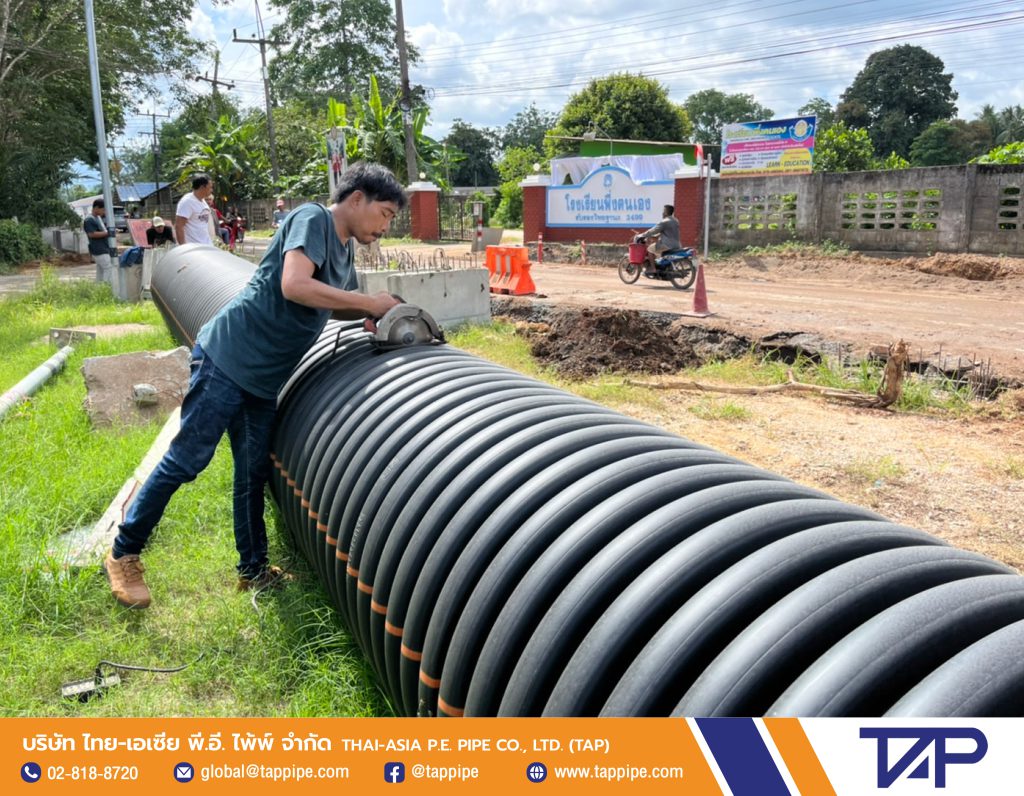 Technician is cutting a corrugated pipe to the appropriate size before laying it